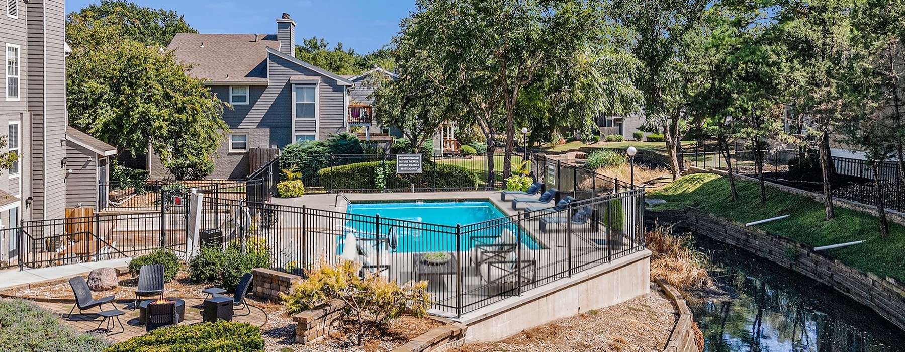 a courtyard with a pool and trees