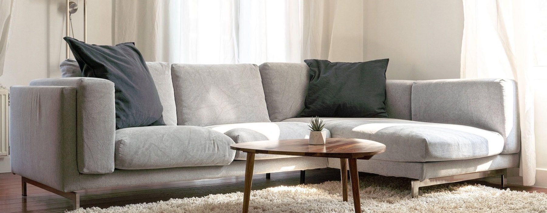 oversized windows brighten spacious, furnished living room