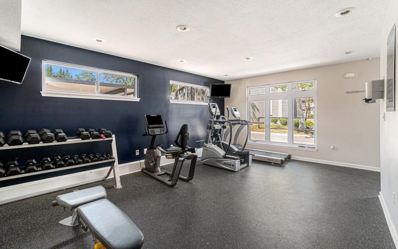 a gym with exercise equipment and a window